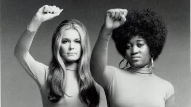 Imagen de Gloria Steinem y Pamela Hughes con el puño levantado