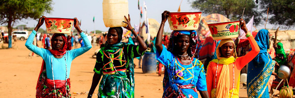 Unas mujeres de Darfur llevan agua