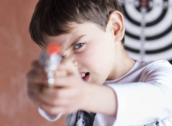 imagen de un niño empuñando una pistola