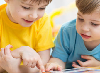 imagen de dos niños viendo un libro