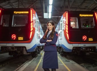 una de las mujeres maquinistas ante dos trenes